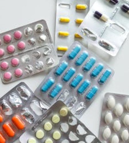 Various colorful medicine tablets in blister packs, emphasizing healthcare and pharmaceutical concepts.